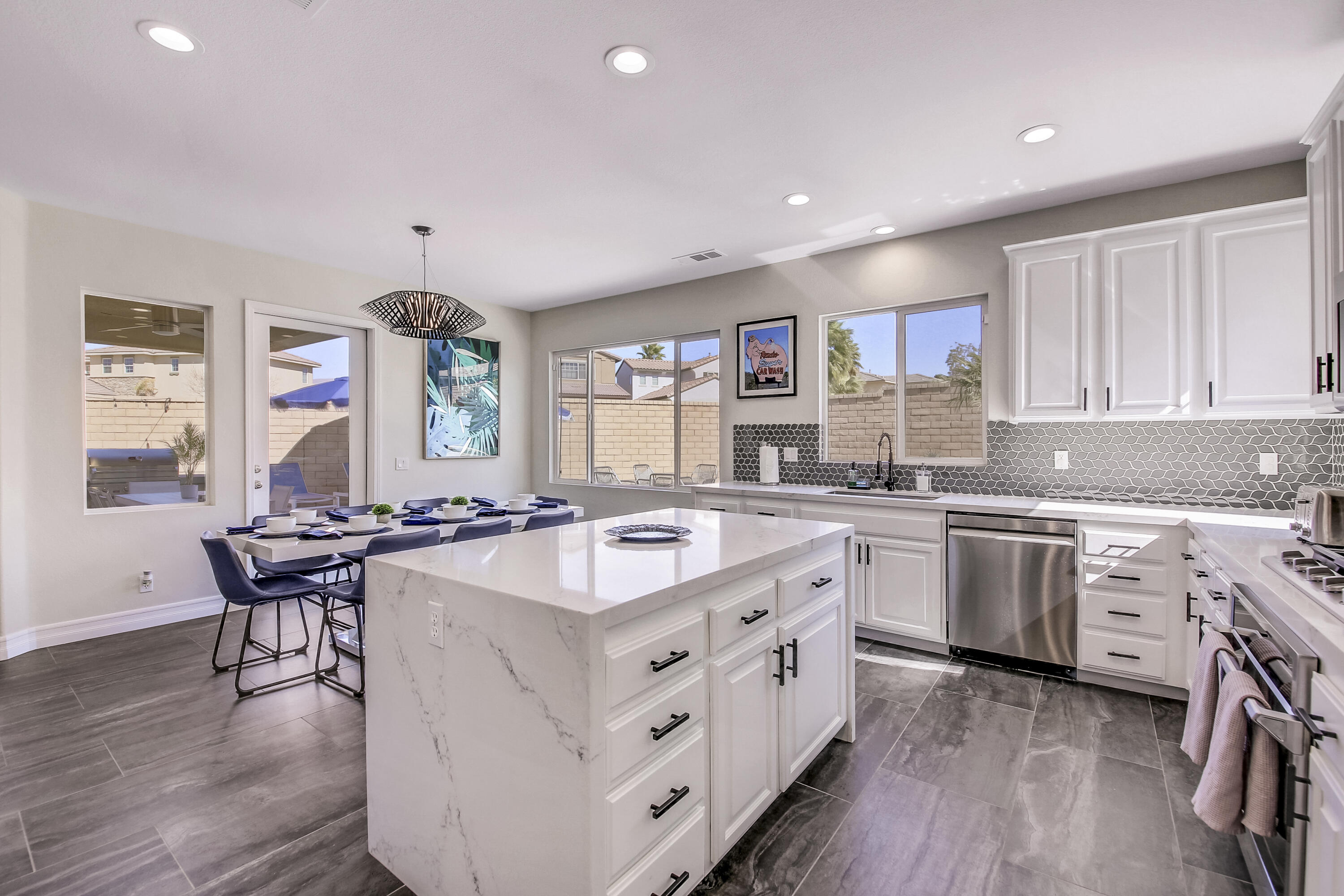 42942 Del Lago Court Indio, CA 92203 - Photo 14 of 75 a open kitchen with cabinets a sink and a stove with wooden floor