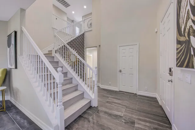 a bedroom with a large bed and a chandelier