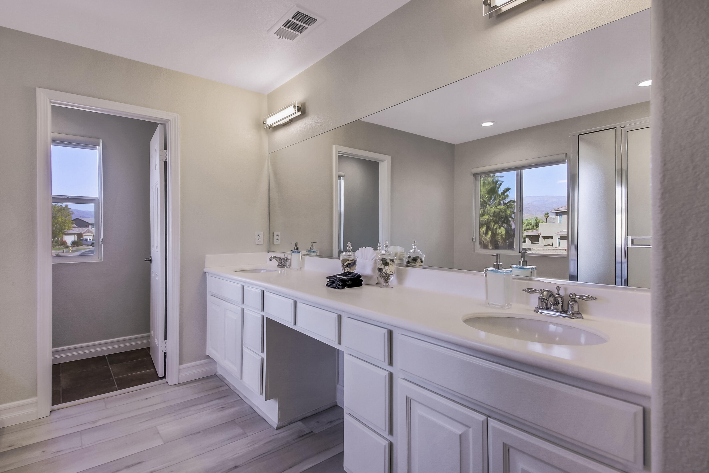42942 Del Lago Court Indio, CA 92203 - Photo 27 of 75 a bathroom with double vanity sinks and a mirror