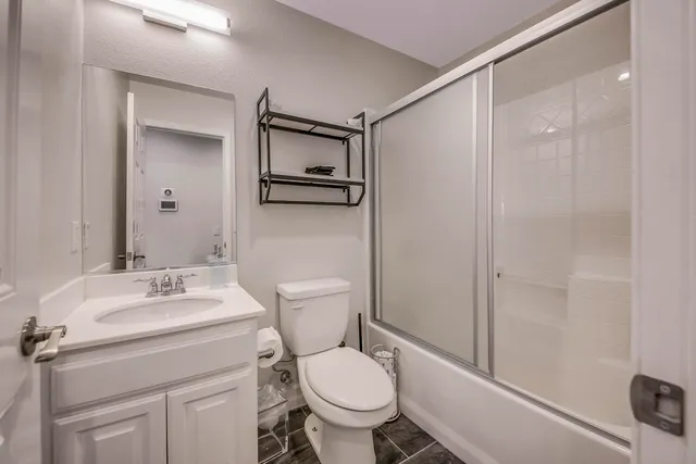 a view of swimming pool with red chairs
