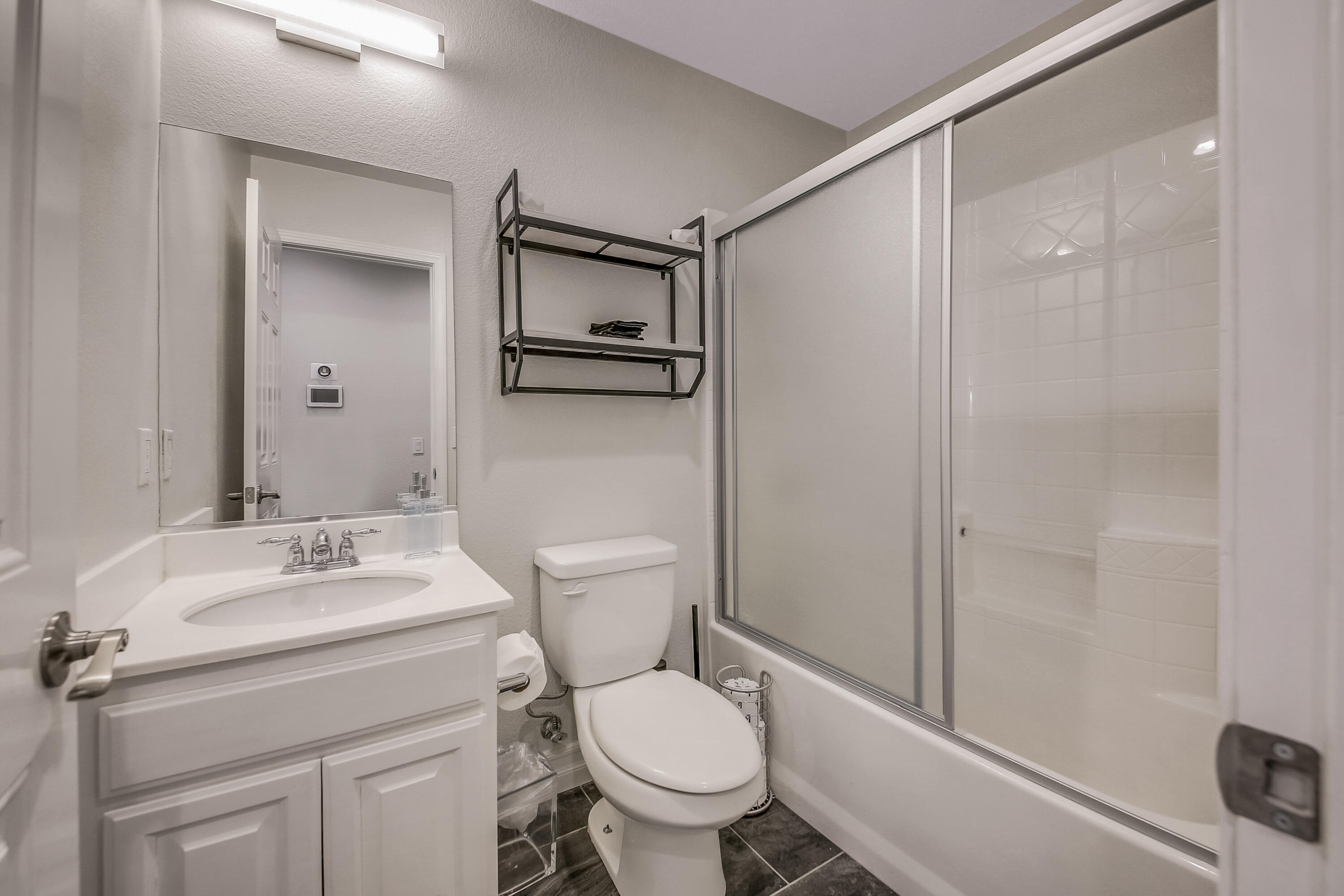 42942 Del Lago Court Indio, CA 92203 - Photo 30 of 75 a bathroom with a granite countertop sink toilet and shower