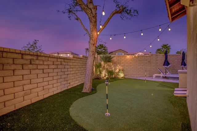 a view of a house with swimming pool and sitting area