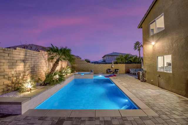 an aerial view of a house with a swimming pool