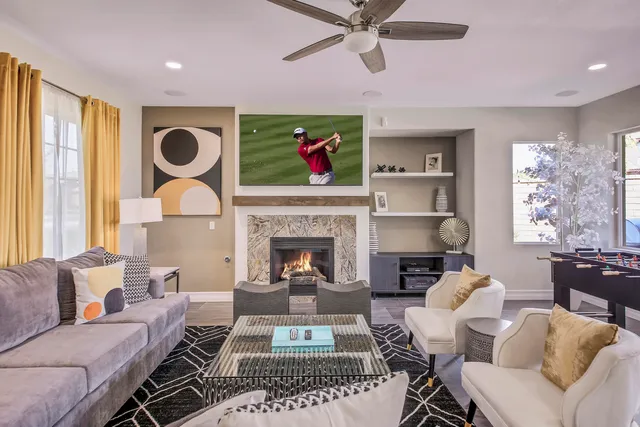 a living room with furniture a fireplace and a flat screen tv