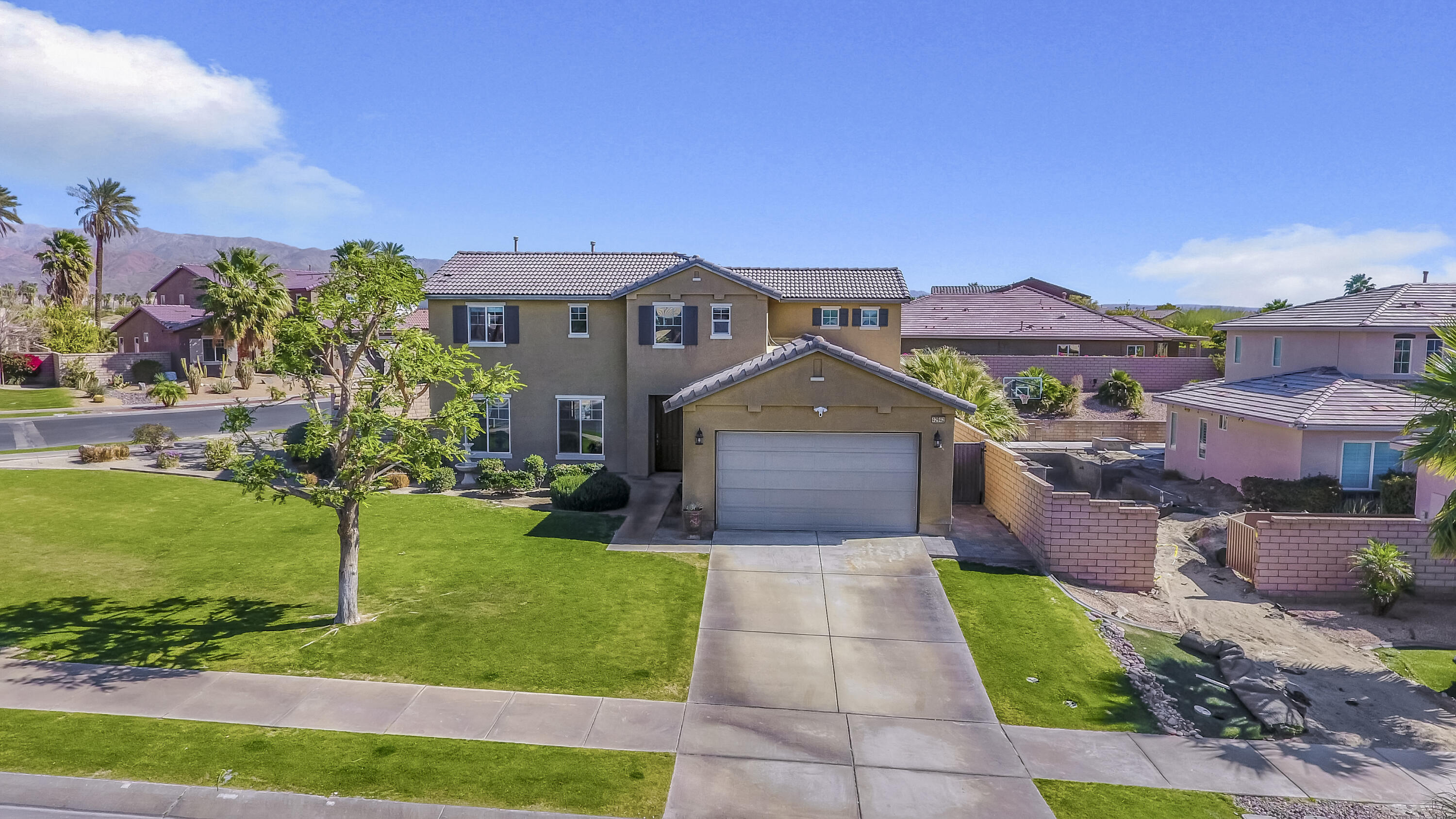 42942 Del Lago Court Indio, CA 92203 - Photo 65 of 75 a front view of a house with a yard and garage