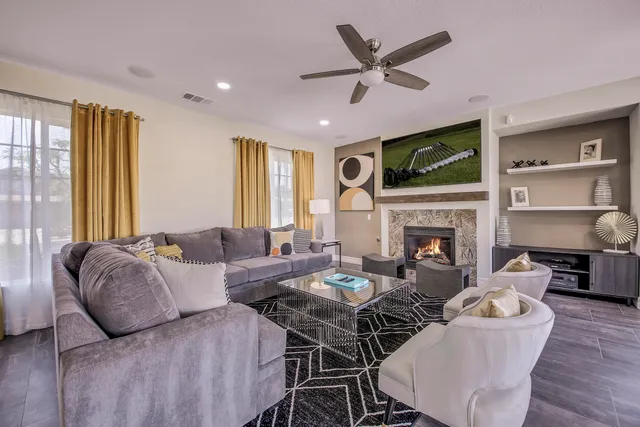 a kitchen with stainless steel appliances granite countertop a stove a refrigerator a kitchen island with a dining table and chairs