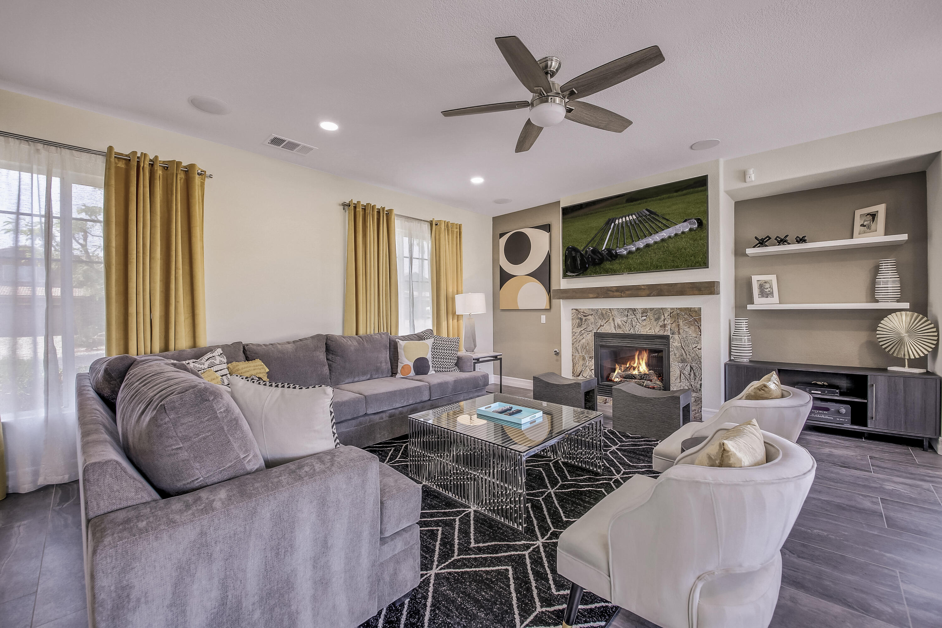 42942 Del Lago Court Indio, CA 92203 - Photo 7 of 75 a living room with furniture a fireplace and a flat screen tv