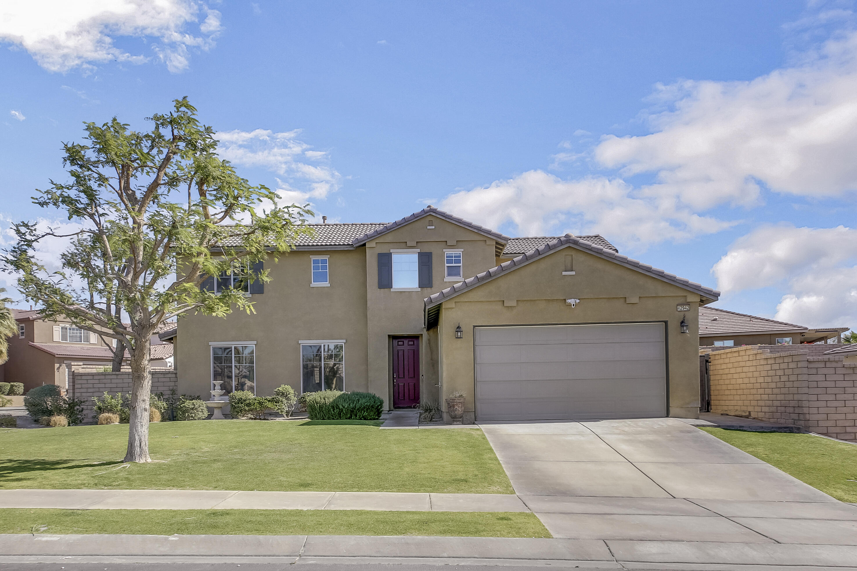 42942 Del Lago Court Indio, CA 92203 - Photo 71 of 75 a front view of a house with a garden and trees