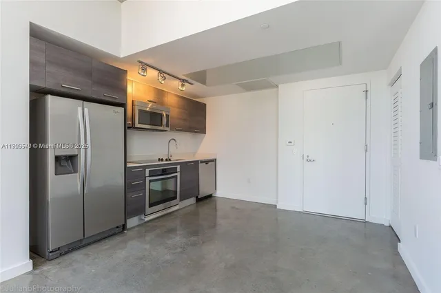 a kitchen with stainless steel appliances and wooden cabinets