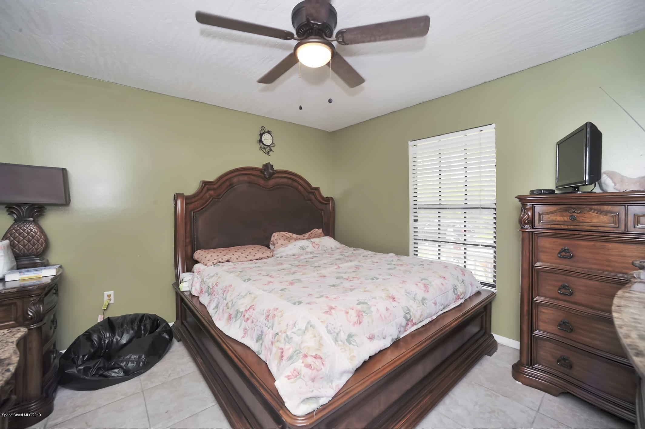 461 Wildmer Road Southwest Palm Bay, FL 32908 - Photo 11 of 15 a bedroom with a bed and a dresser