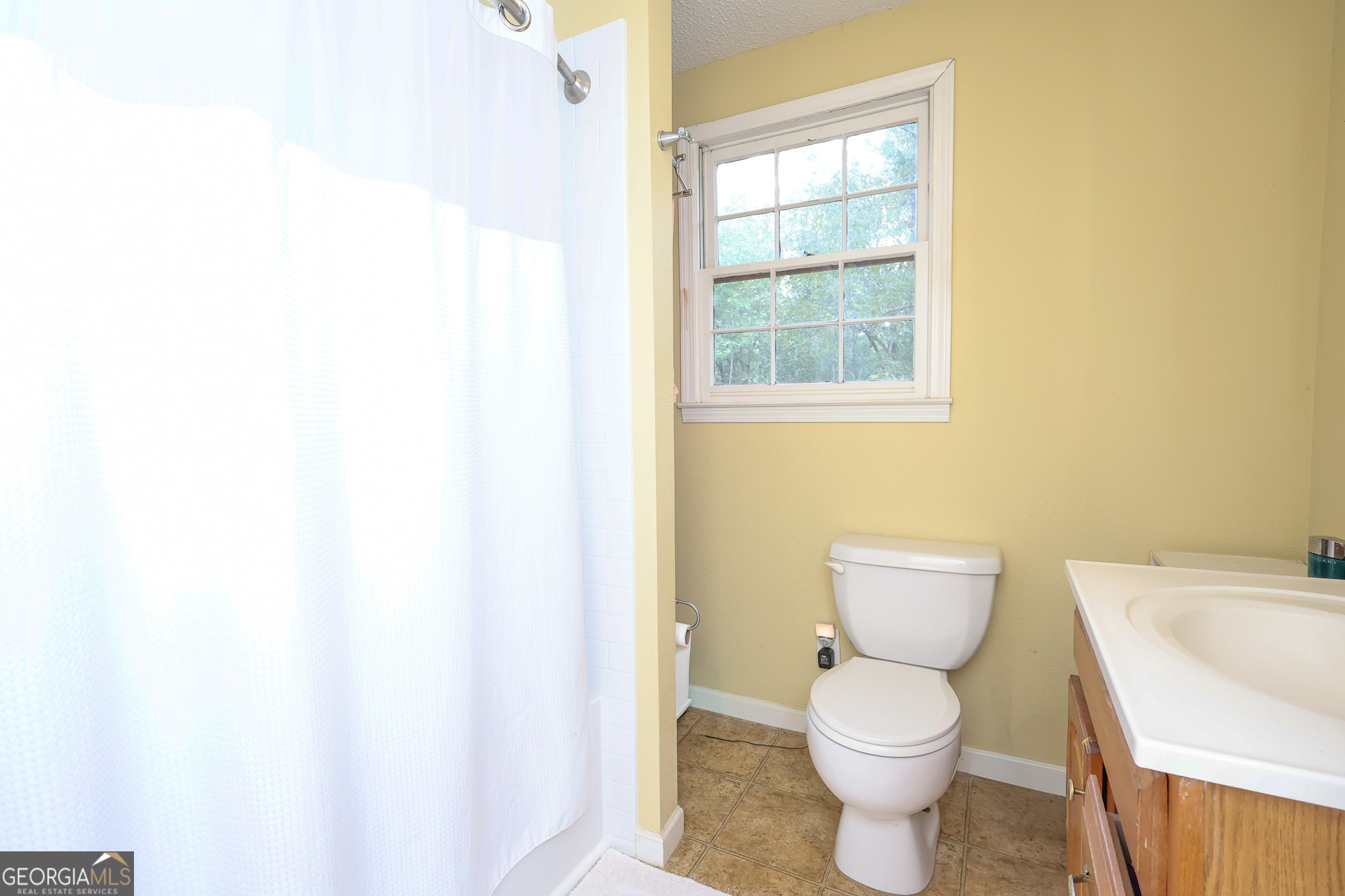 299 Chapman Road Lizella, GA 31052 - Photo 14 of 21 a white toilet sitting next to a bathroom sink