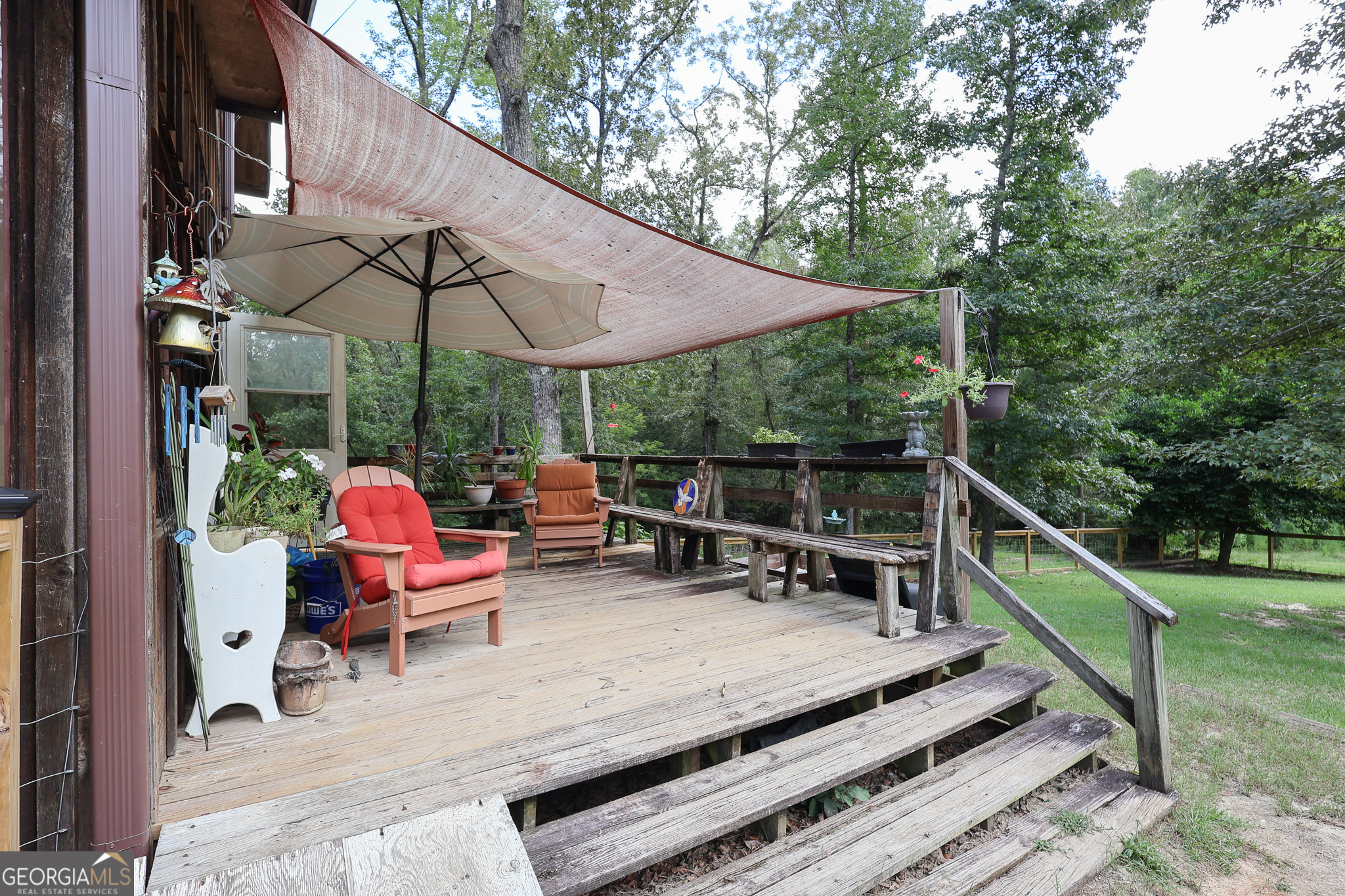 299 Chapman Road Lizella, GA 31052 - Photo 18 of 21 a view of deck with chairs and table under an umbrella