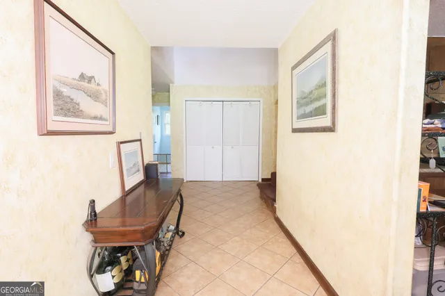 a view of a hallway with furniture and a potted plant