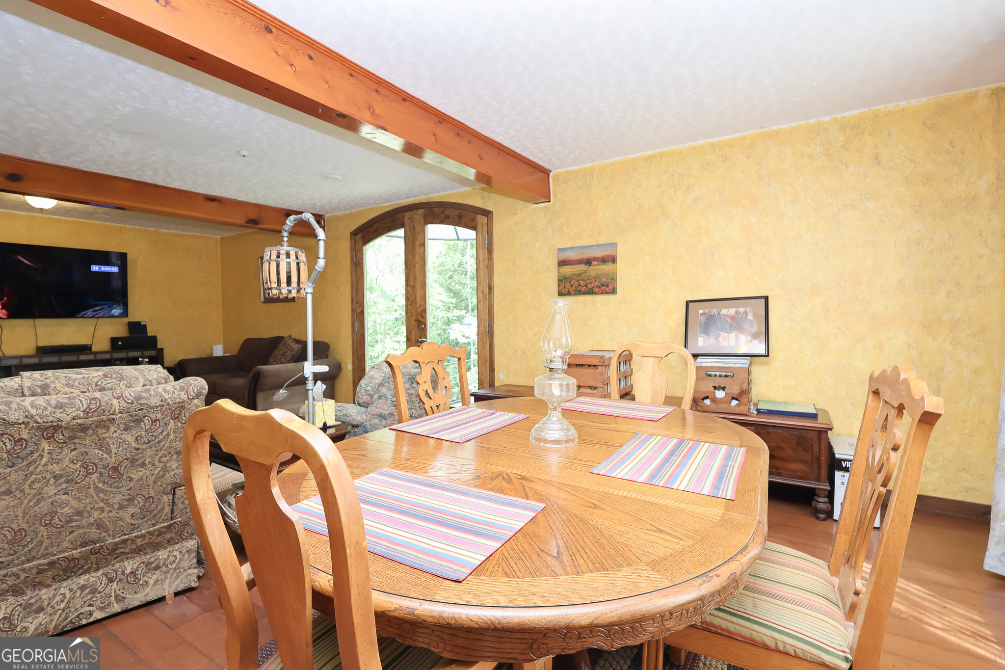 299 Chapman Road Lizella, GA 31052 - Photo 8 of 21 a dining room with furniture a window and wooden floor
