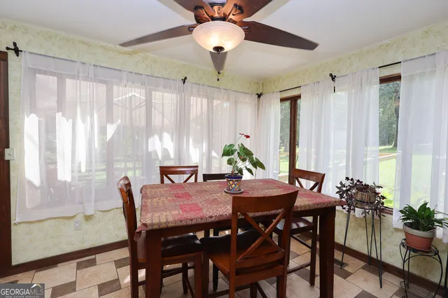 a view of a dining room with furniture and window