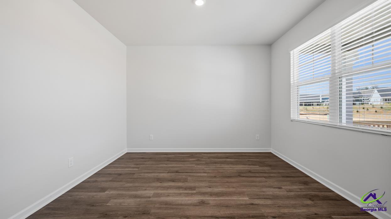 227 Cattle Drive Perry, GA 31069 - Photo 18 of 40 a view of an empty room with wooden floor and a window