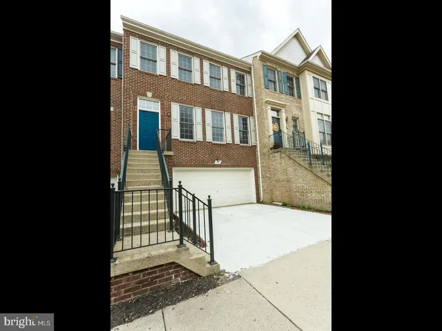 a view of a brick house that has two windows