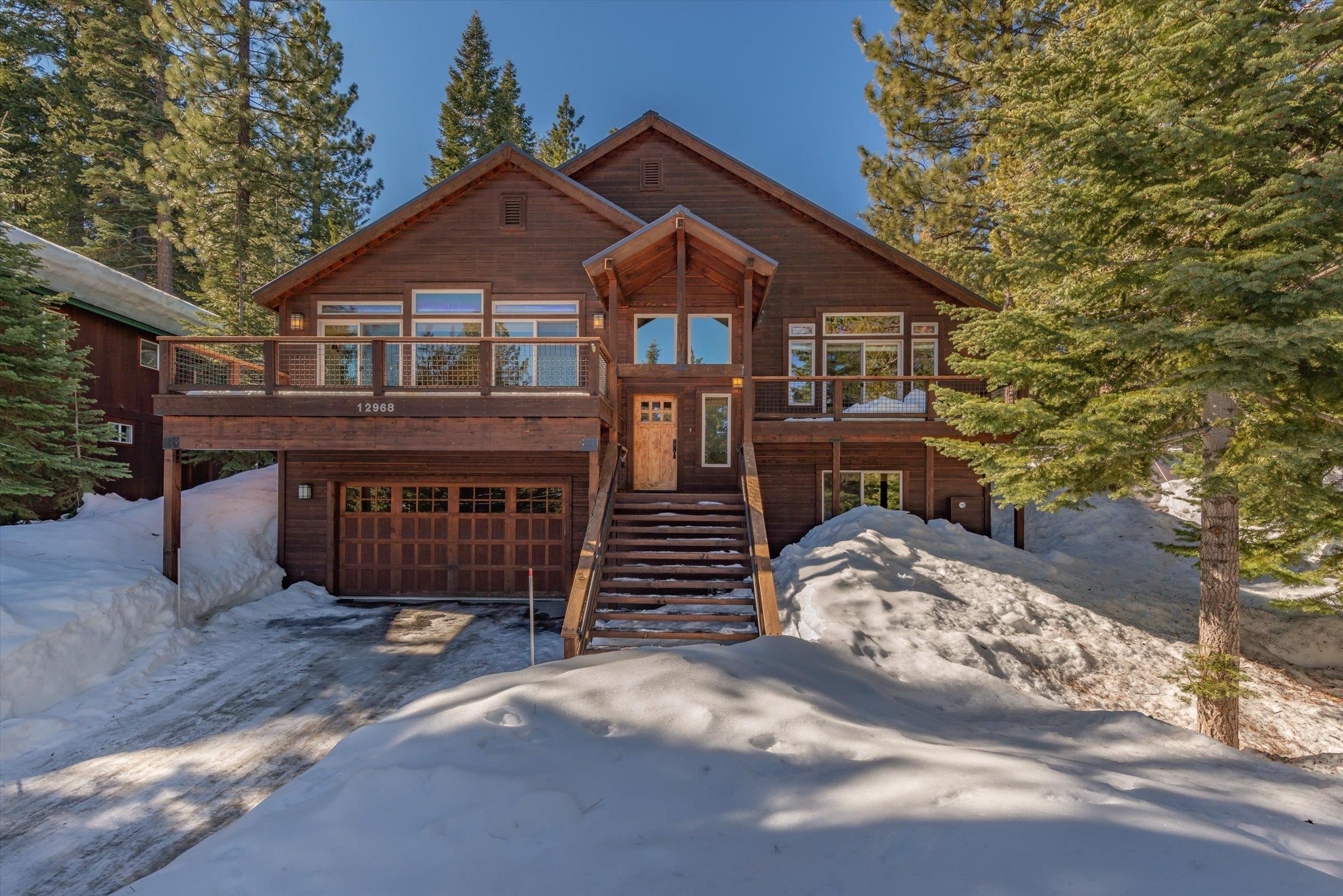 12968 Solvang Way Truckee, CA 96161 - Photo 1 of 21 a front view of a house with a yard and garage