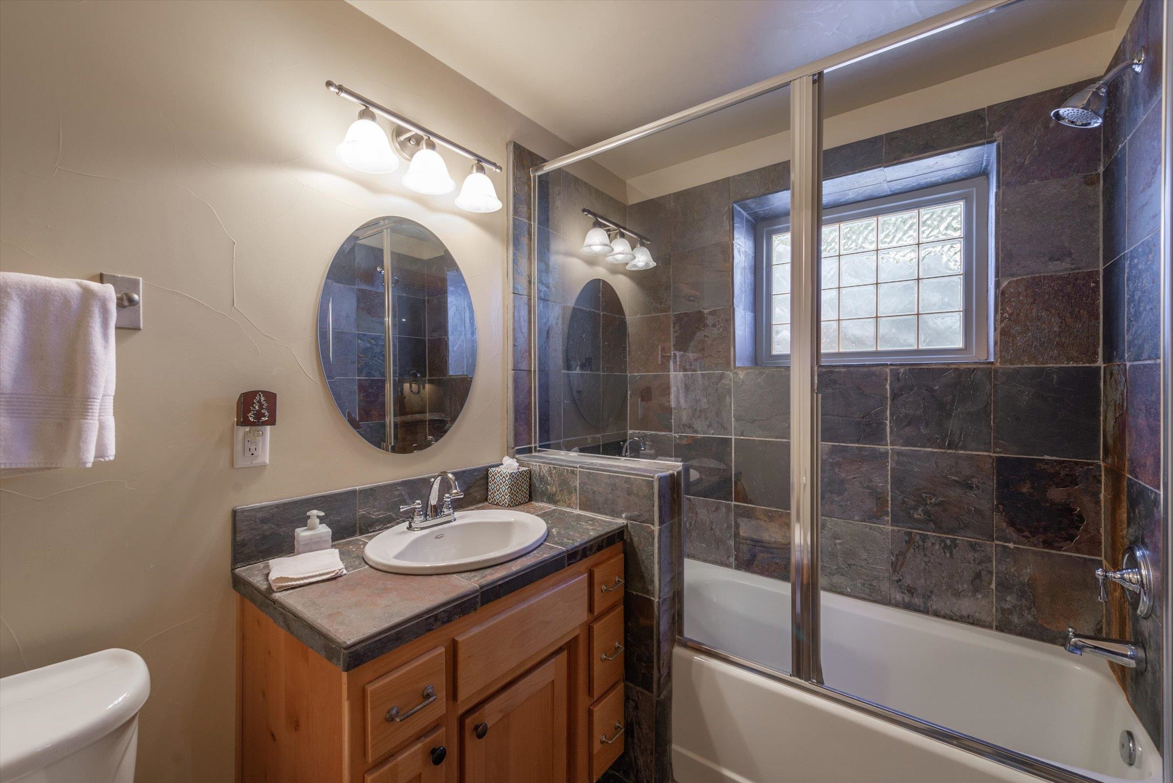 12968 Solvang Way Truckee, CA 96161 - Photo 15 of 21 a bathroom with a sink vanity mirror and tub