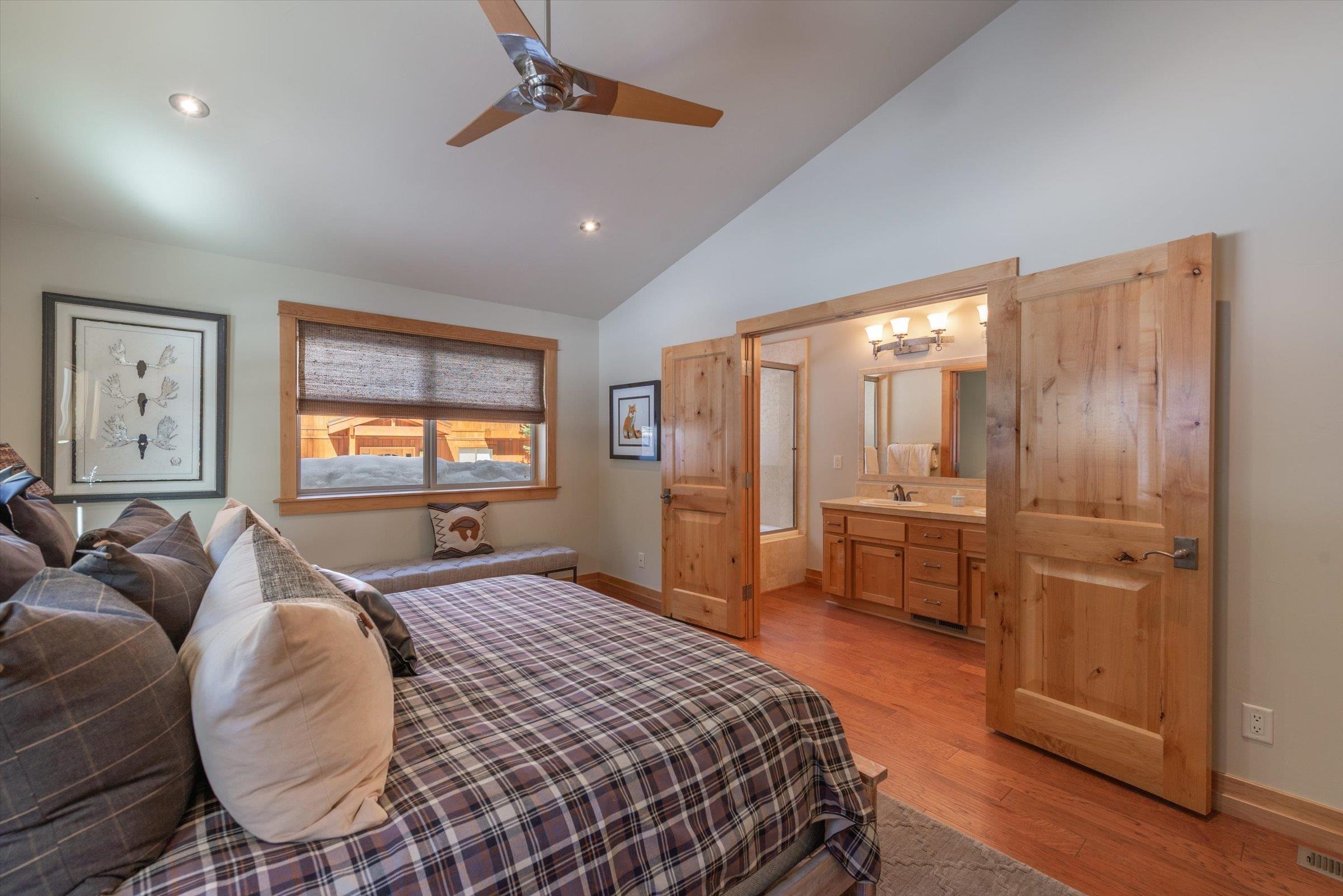 12968 Solvang Way Truckee, CA 96161 - Photo 16 of 21 a spacious bedroom with a bed a dresser and wooden floor