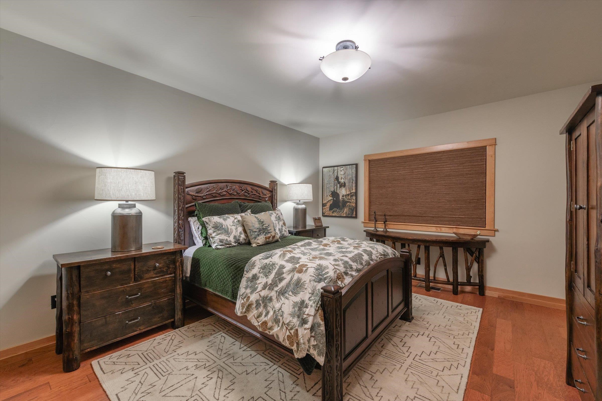 12968 Solvang Way Truckee, CA 96161 - Photo 20 of 21 a bedroom with a bed and a chandelier