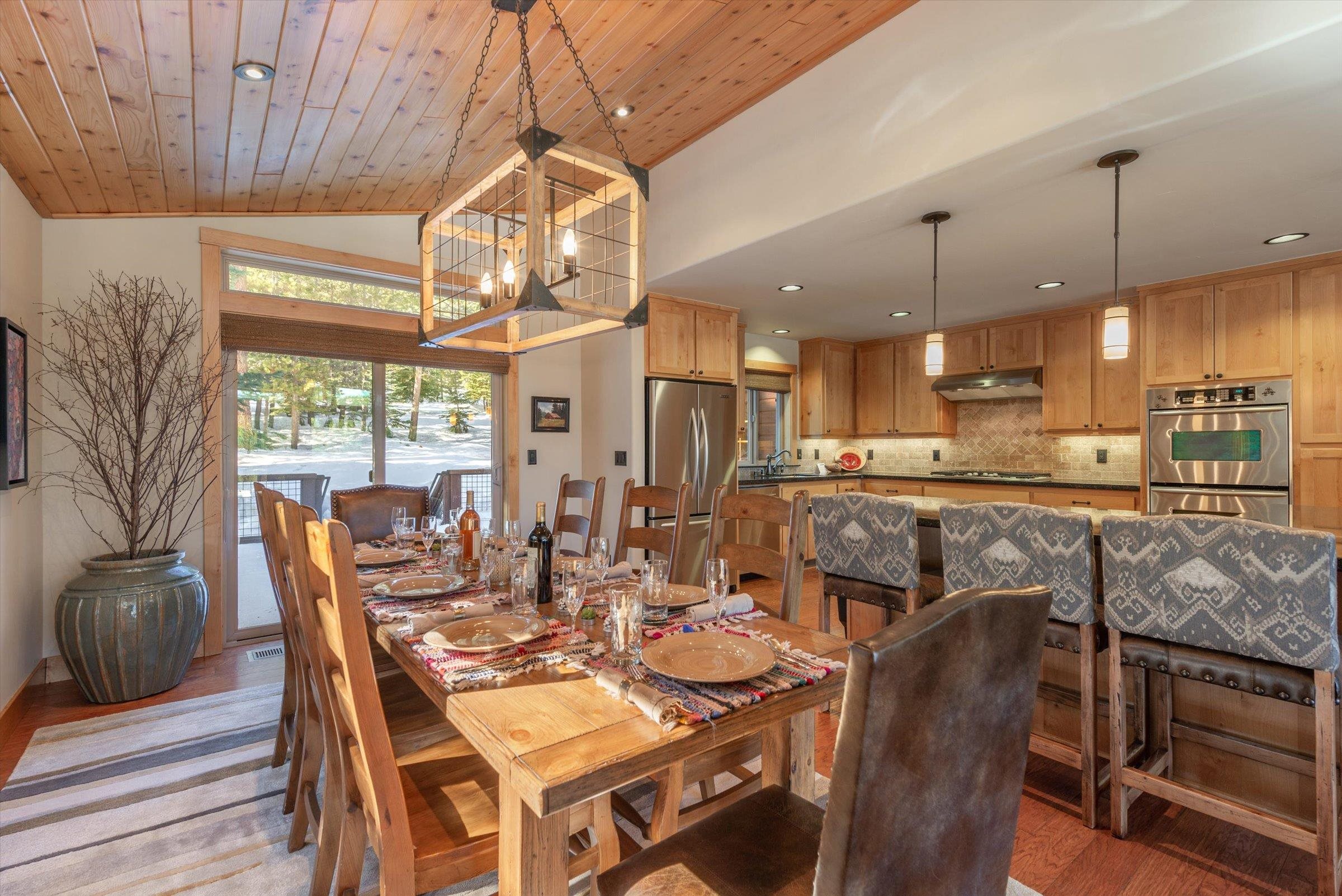 12968 Solvang Way Truckee, CA 96161 - Photo 5 of 21 a dining room with stainless steel appliances granite countertop a table chairs and a chandelier