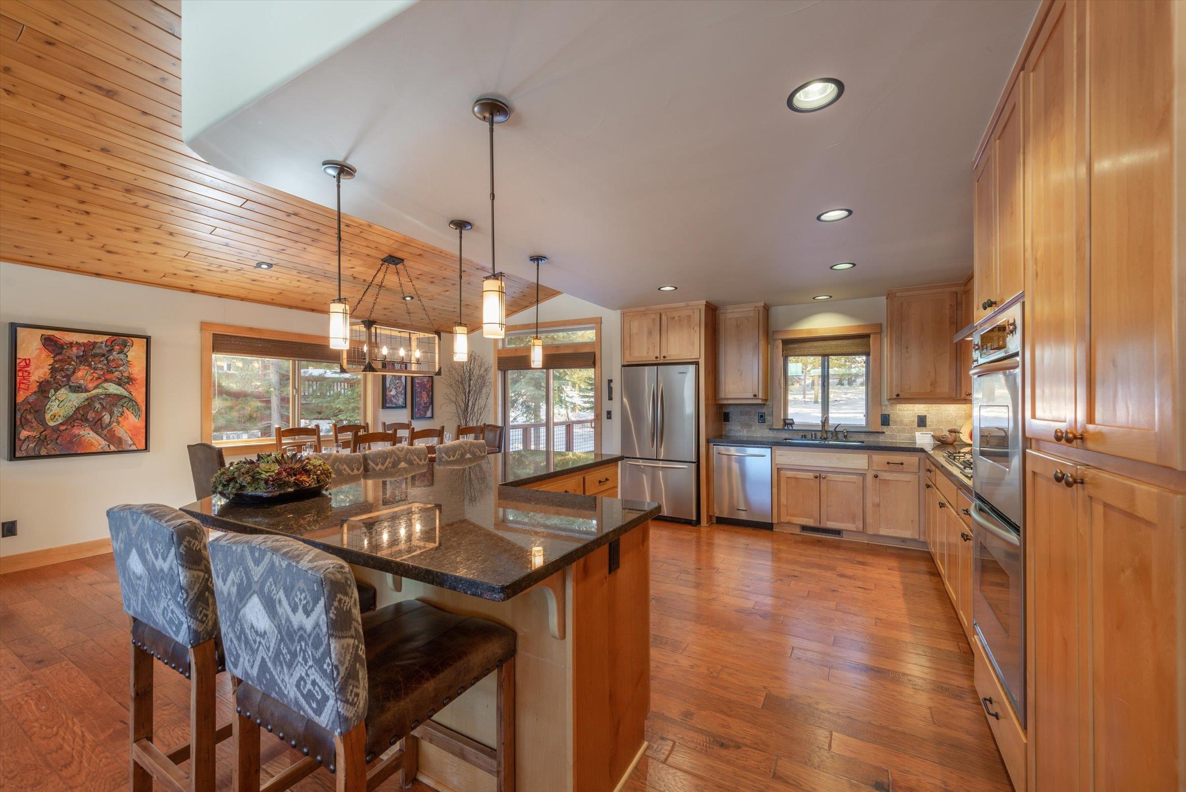 12968 Solvang Way Truckee, CA 96161 - Photo 7 of 21 a dining hall with stainless steel appliances kitchen island granite countertop a table chairs and a rug