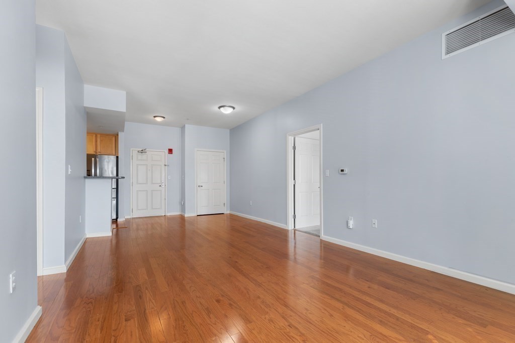 36 Village Road, Unit 306 Middleton, MA 01949 - Photo 13 of 38 a view of an empty room and wooden floor