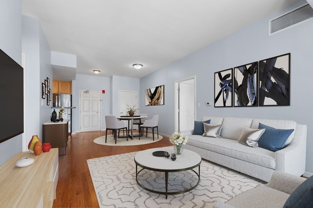 36 Village Road, Unit 306 Middleton, MA 01949 - Photo 14 of 38 a living room with furniture and a wooden floor