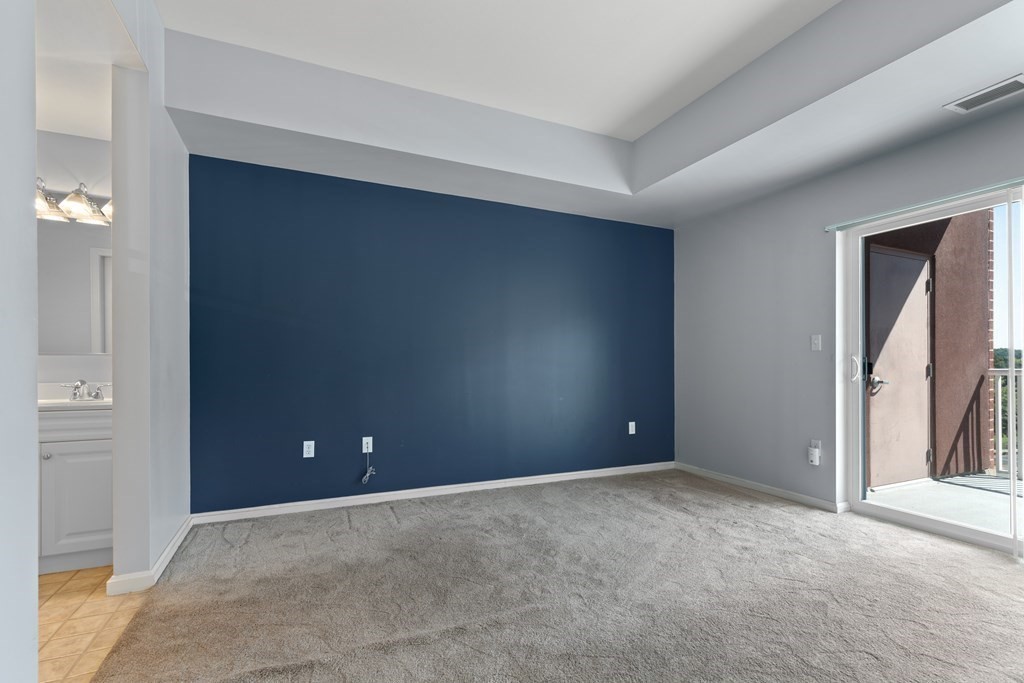 36 Village Road, Unit 306 Middleton, MA 01949 - Photo 15 of 38 an empty room with closet and windows