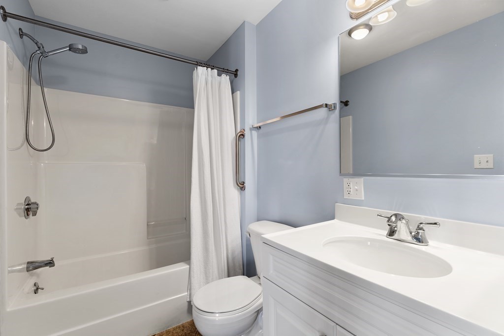 36 Village Road, Unit 306 Middleton, MA 01949 - Photo 24 of 38 a bathroom with a granite countertop sink toilet and shower