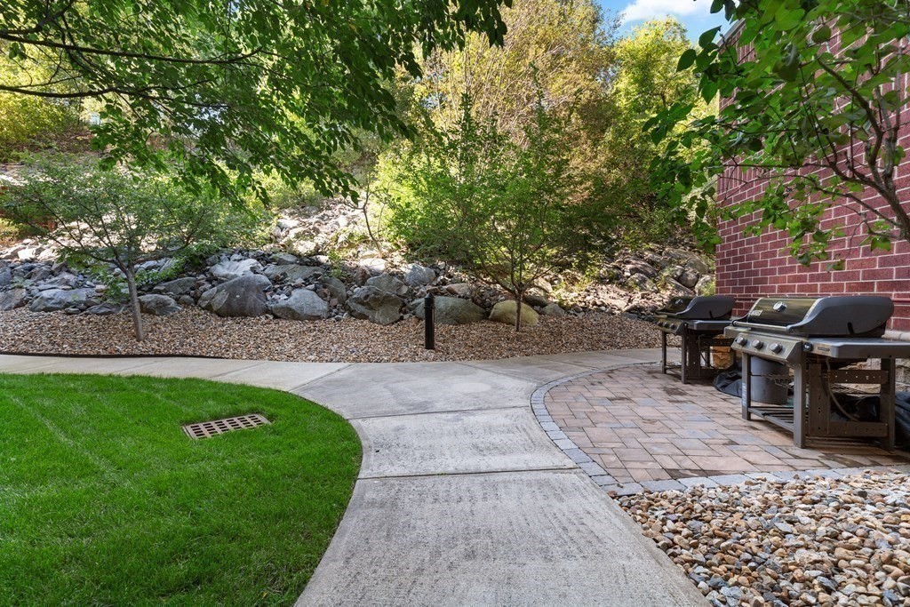 36 Village Road, Unit 306 Middleton, MA 01949 - Photo 33 of 38 a view of a backyard with sitting area