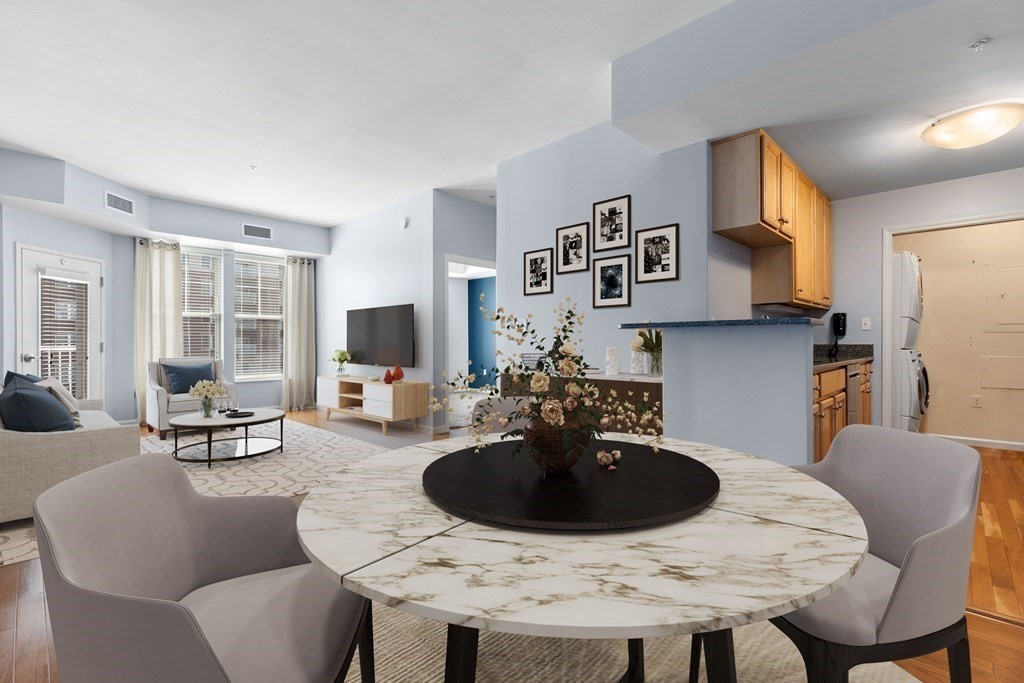 36 Village Road, Unit 306 Middleton, MA 01949 - Photo 7 of 38 a kitchen with stainless steel appliances a dining table and chairs