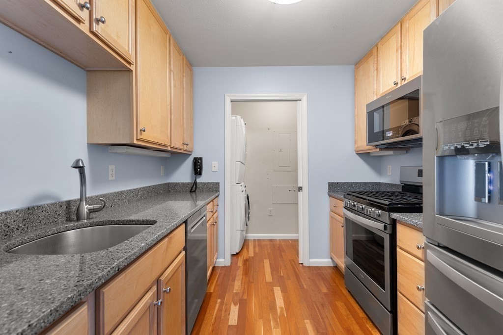 36 Village Road, Unit 306 Middleton, MA 01949 - Photo 10 of 38 a kitchen with stainless steel appliances granite countertop a sink a stove and cabinets