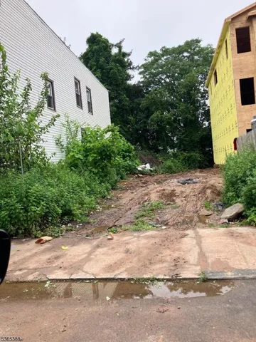 a white house that has a tree in front of it