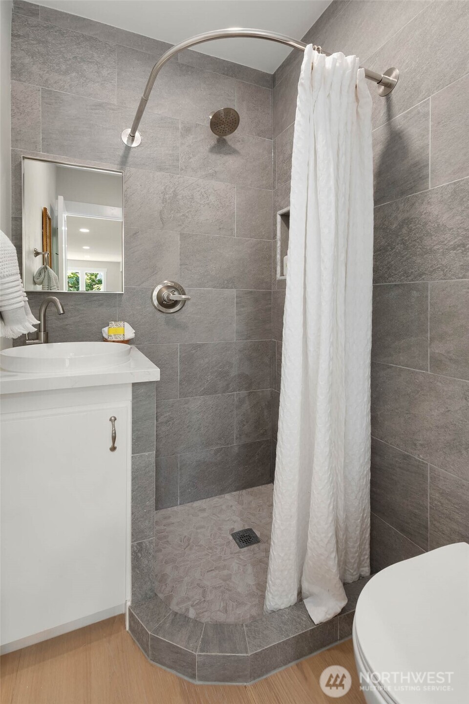 1312 Northeast 70th Street Seattle, WA 98115 - Photo 18 of 36 a bathroom with a sink a toilet and shower