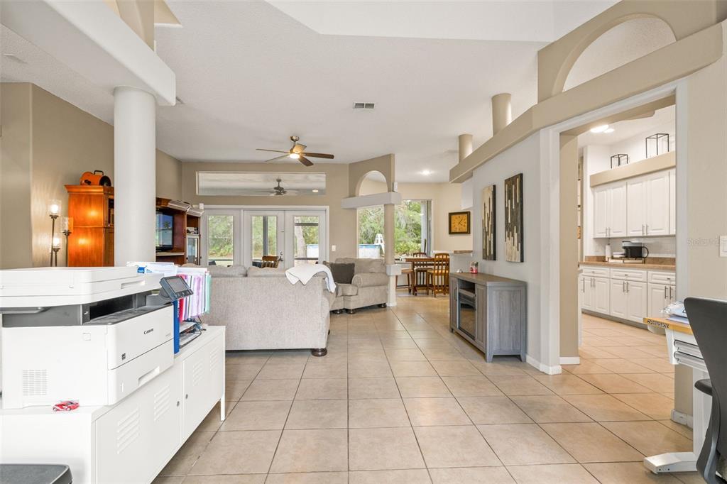 11128 Lomita Wren Road Weeki Wachee, FL 34614 - Photo 11 of 39 a large kitchen with stainless steel appliances kitchen island granite countertop a stove a sink a dining table and chairs
