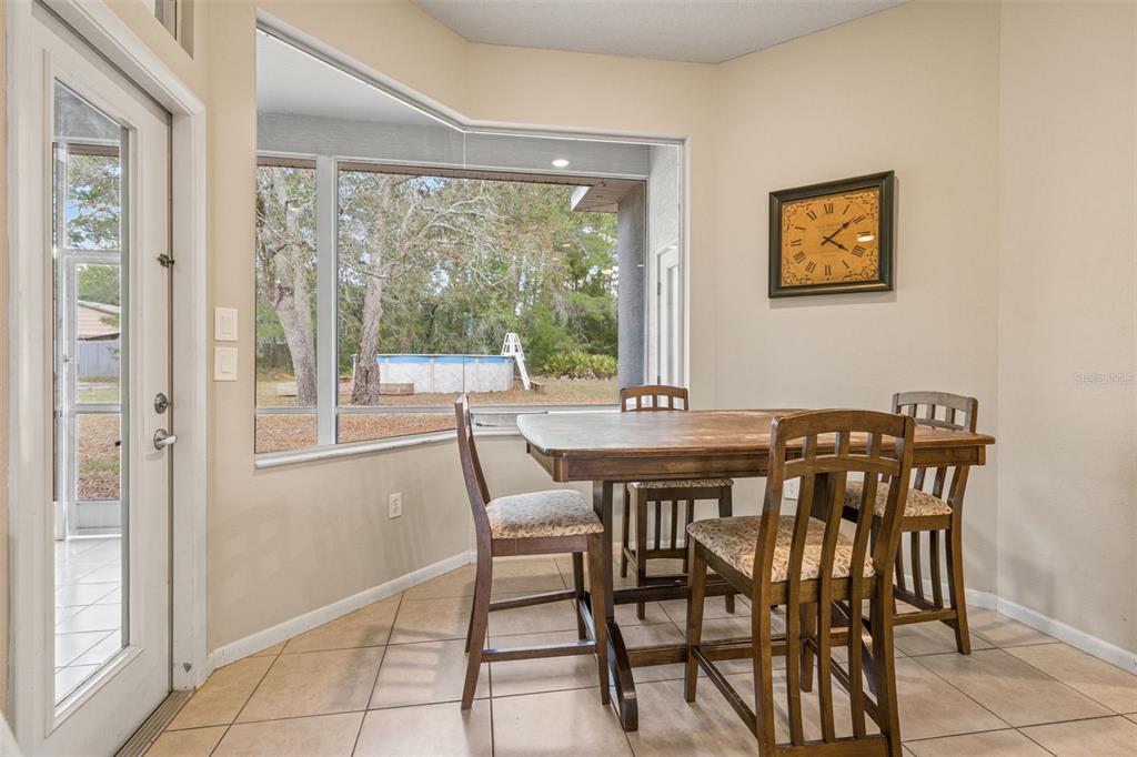 11128 Lomita Wren Road Weeki Wachee, FL 34614 - Photo 12 of 39 a view of a dining room with furniture window and outside view