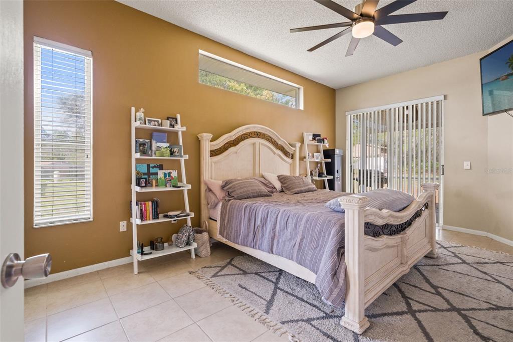 11128 Lomita Wren Road Weeki Wachee, FL 34614 - Photo 16 of 39 a bedroom with a bed and a window