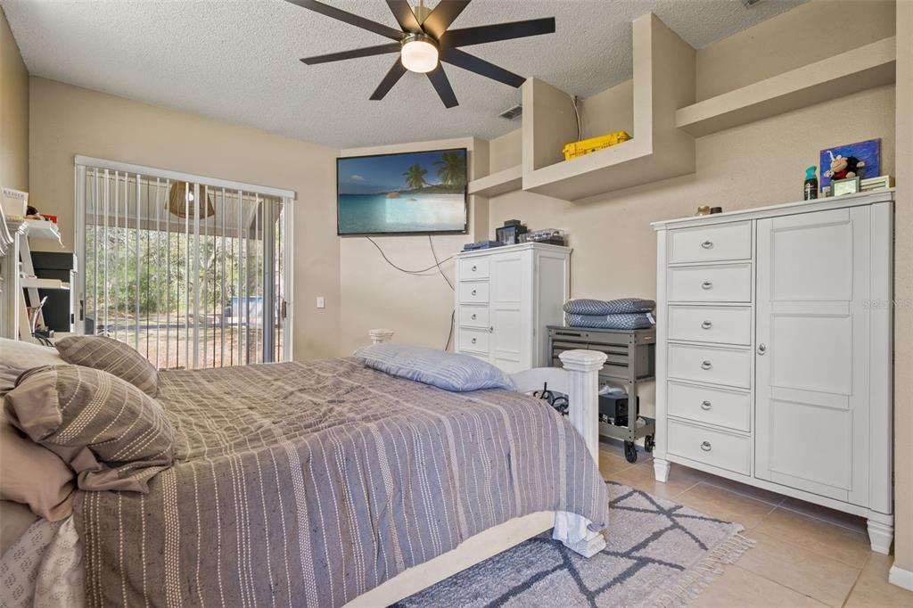 11128 Lomita Wren Road Weeki Wachee, FL 34614 - Photo 17 of 39 a bedroom with a bed and a window