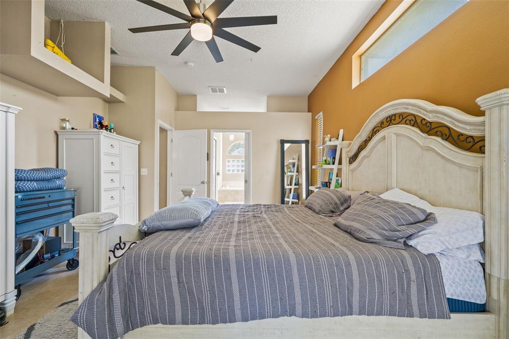 11128 Lomita Wren Road Weeki Wachee, FL 34614 - Photo 18 of 39 a bedroom with a bed and a ceiling fan