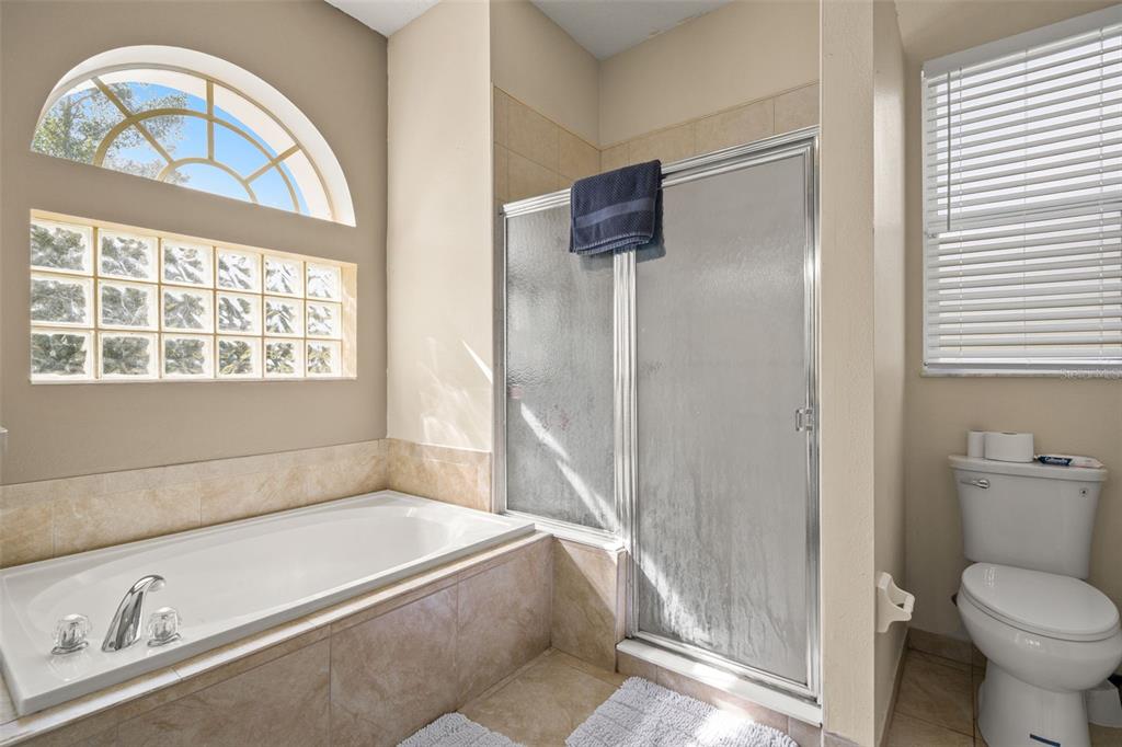 11128 Lomita Wren Road Weeki Wachee, FL 34614 - Photo 19 of 39 a bath room with a toilet and a bath tub