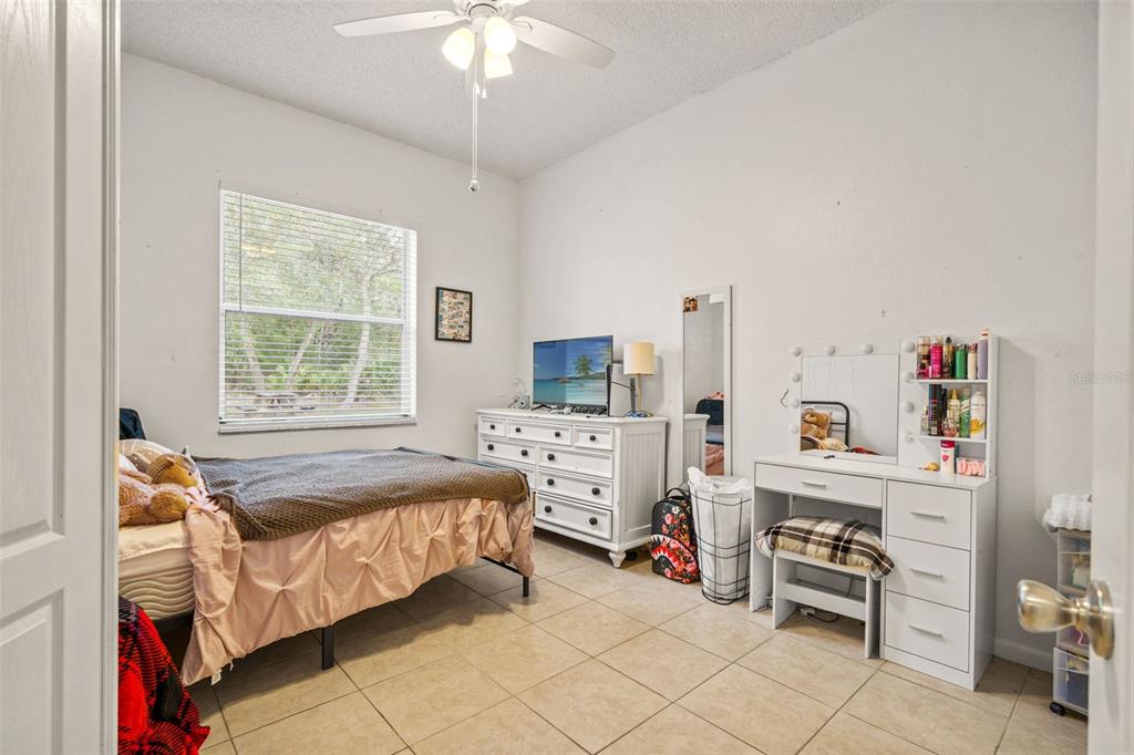 11128 Lomita Wren Road Weeki Wachee, FL 34614 - Photo 22 of 39 a bedroom with furniture and a window