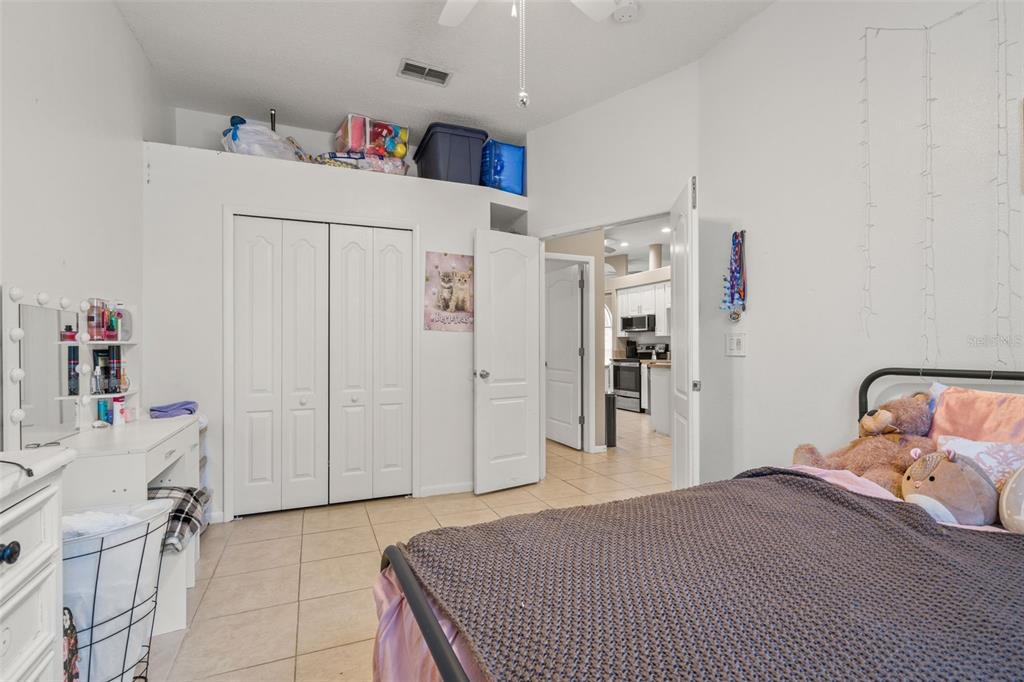 11128 Lomita Wren Road Weeki Wachee, FL 34614 - Photo 23 of 39 a bedroom with a bed and a cabinets