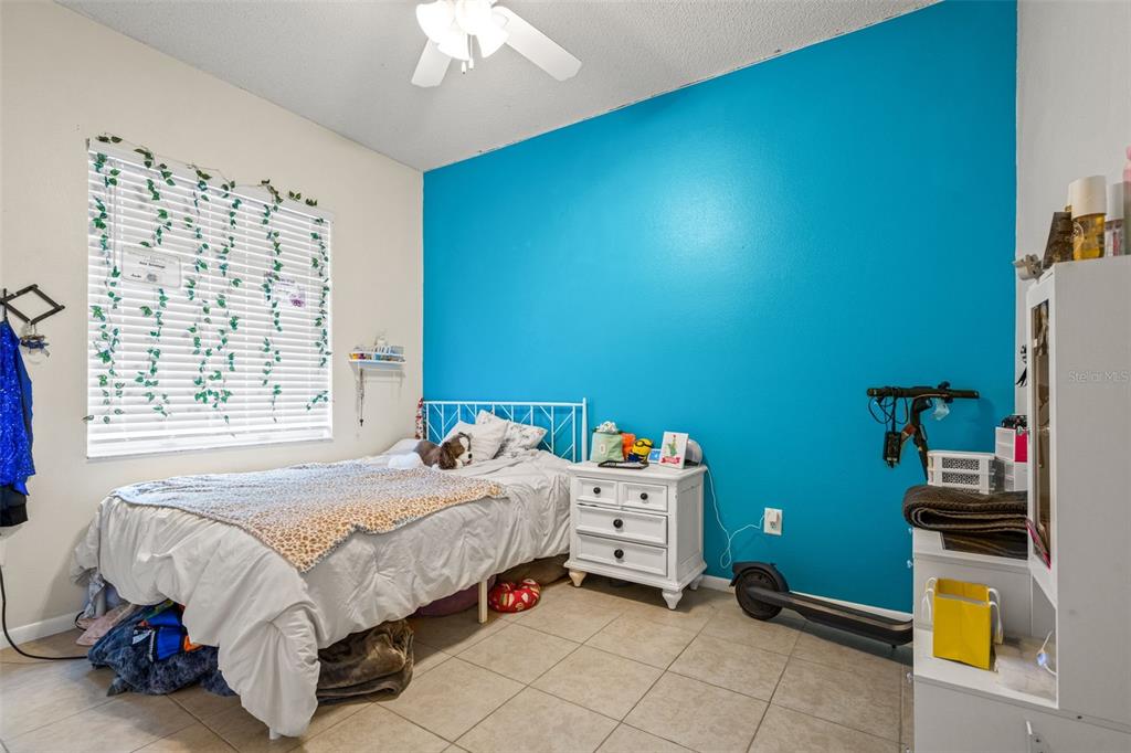 11128 Lomita Wren Road Weeki Wachee, FL 34614 - Photo 24 of 39 a bedroom with a bed and a window