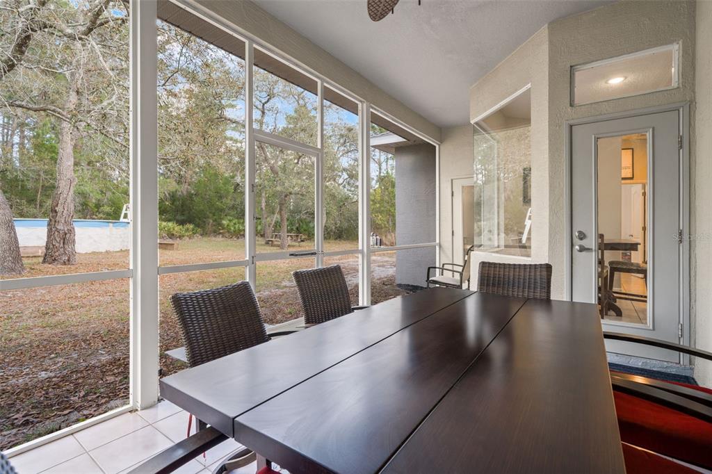 11128 Lomita Wren Road Weeki Wachee, FL 34614 - Photo 27 of 39 a living room with furniture and a floor to ceiling window