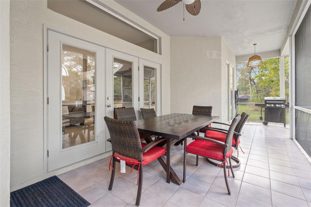 11128 Lomita Wren Road Weeki Wachee, FL 34614 - Photo 28 of 39 a view of a dining room with furniture window and wooden floor