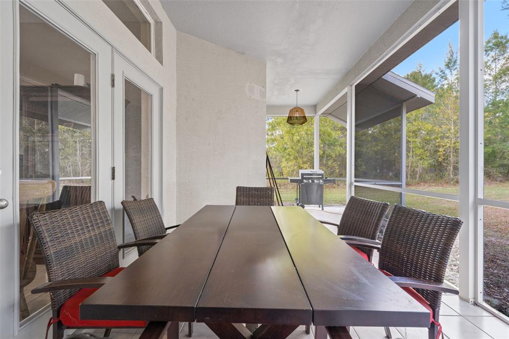 11128 Lomita Wren Road Weeki Wachee, FL 34614 - Photo 30 of 39 a view of a dining room with furniture window and outside view