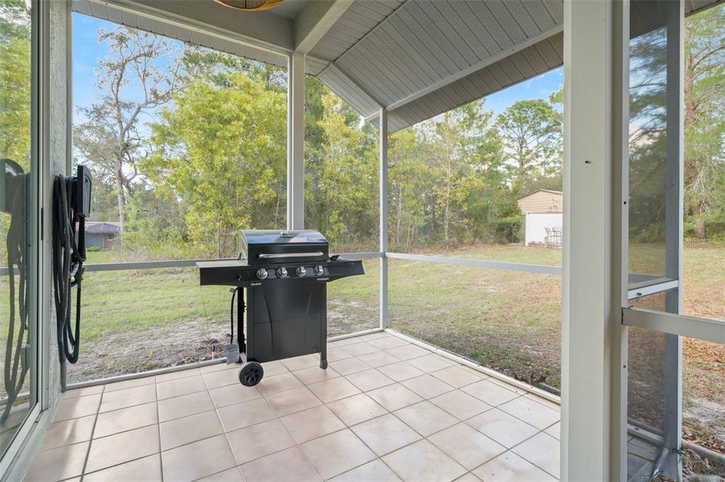 11128 Lomita Wren Road Weeki Wachee, FL 34614 - Photo 32 of 39 a view of a porch with chairs and backyard