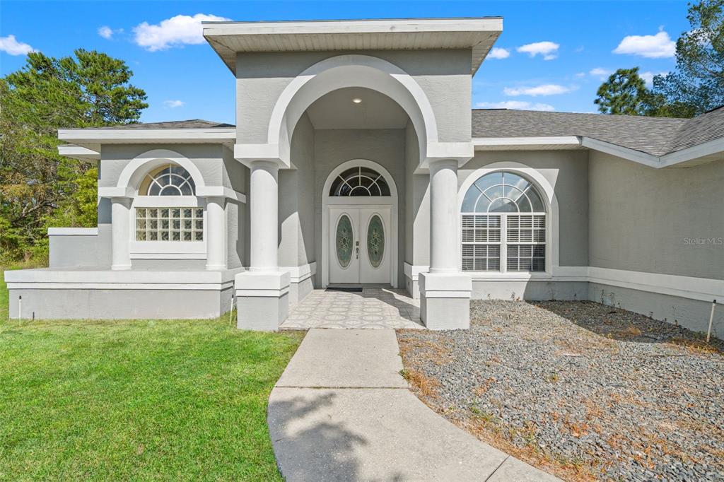 11128 Lomita Wren Road Weeki Wachee, FL 34614 - Photo 4 of 39 a front view of a house with garden